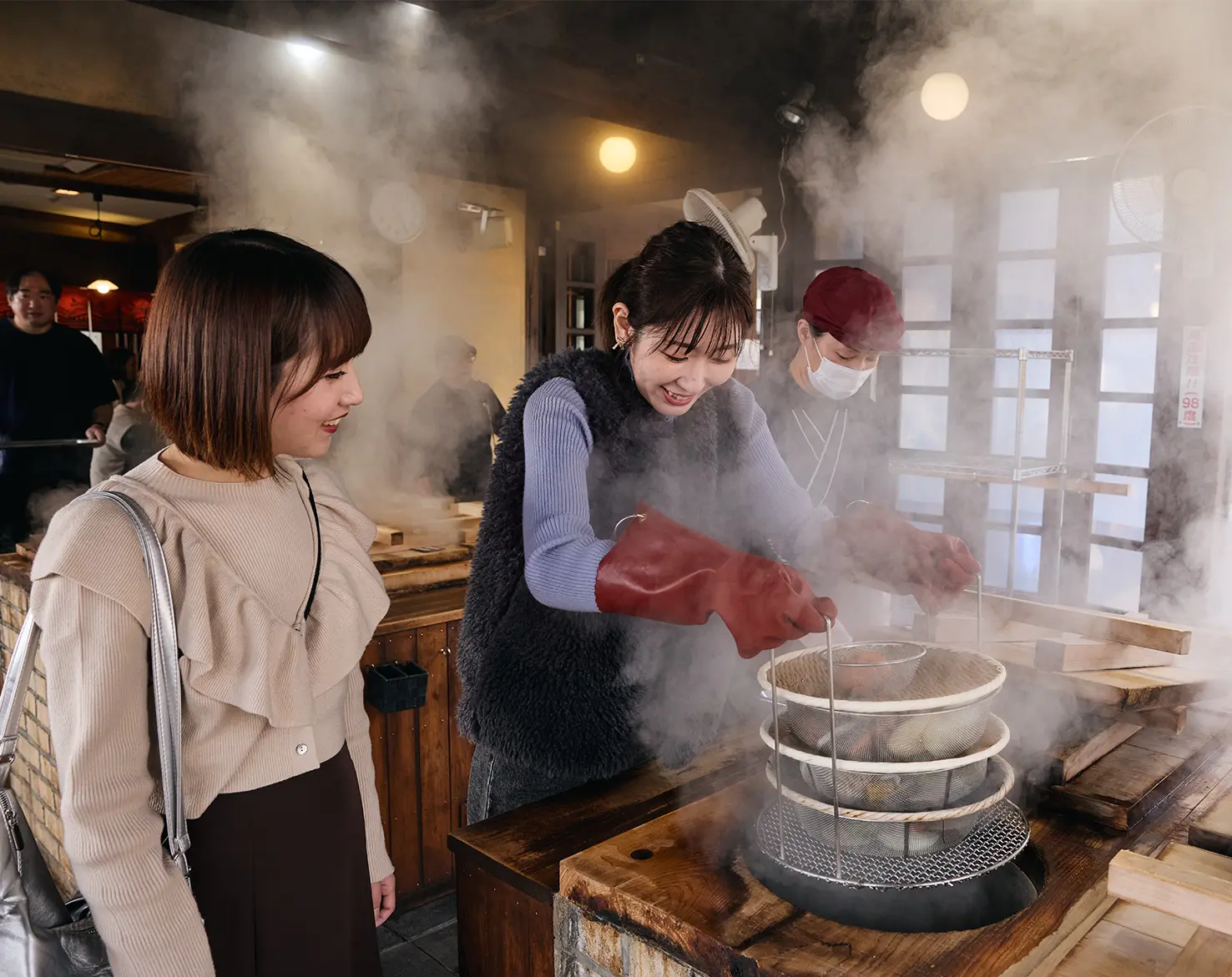 Two people cooking with steam in Beppu – culinary insider tip in Japan