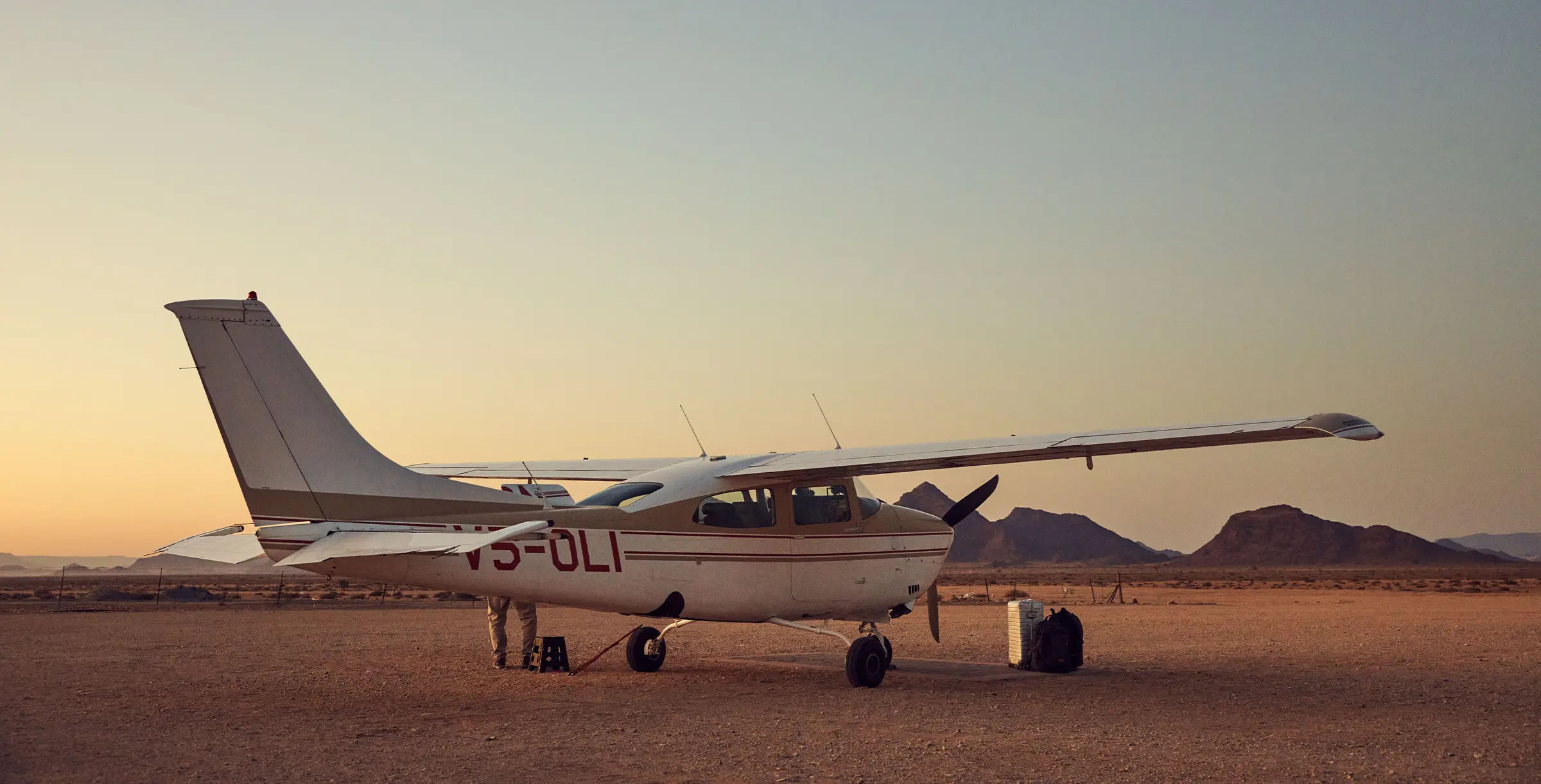 Cessna in front of mountains