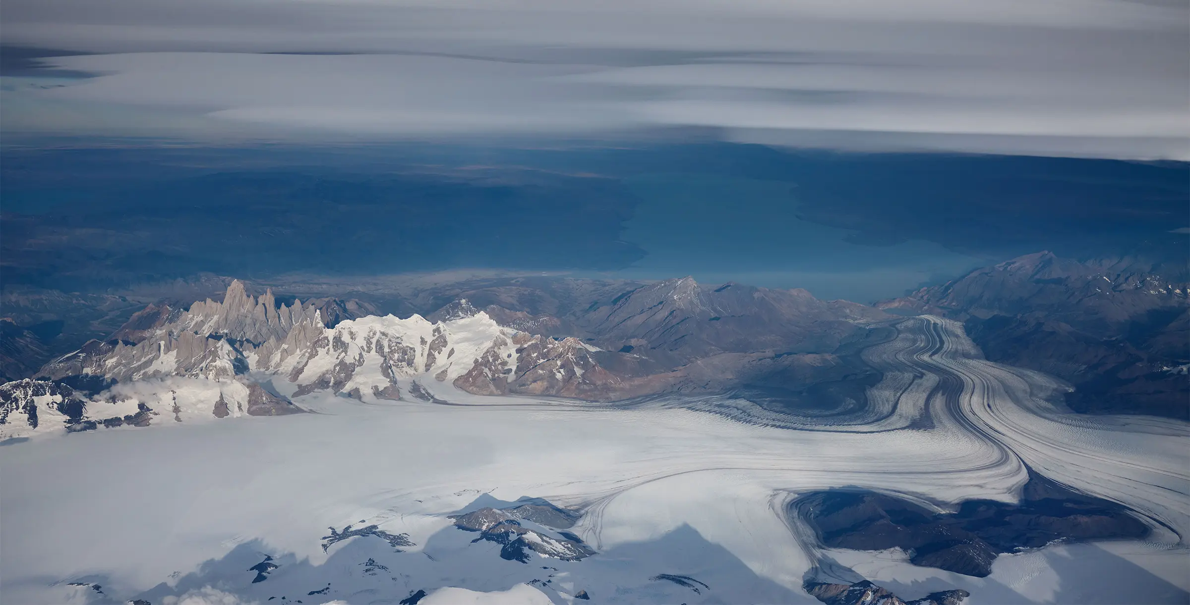 Aerial view of a mountain range with an extensive glacier