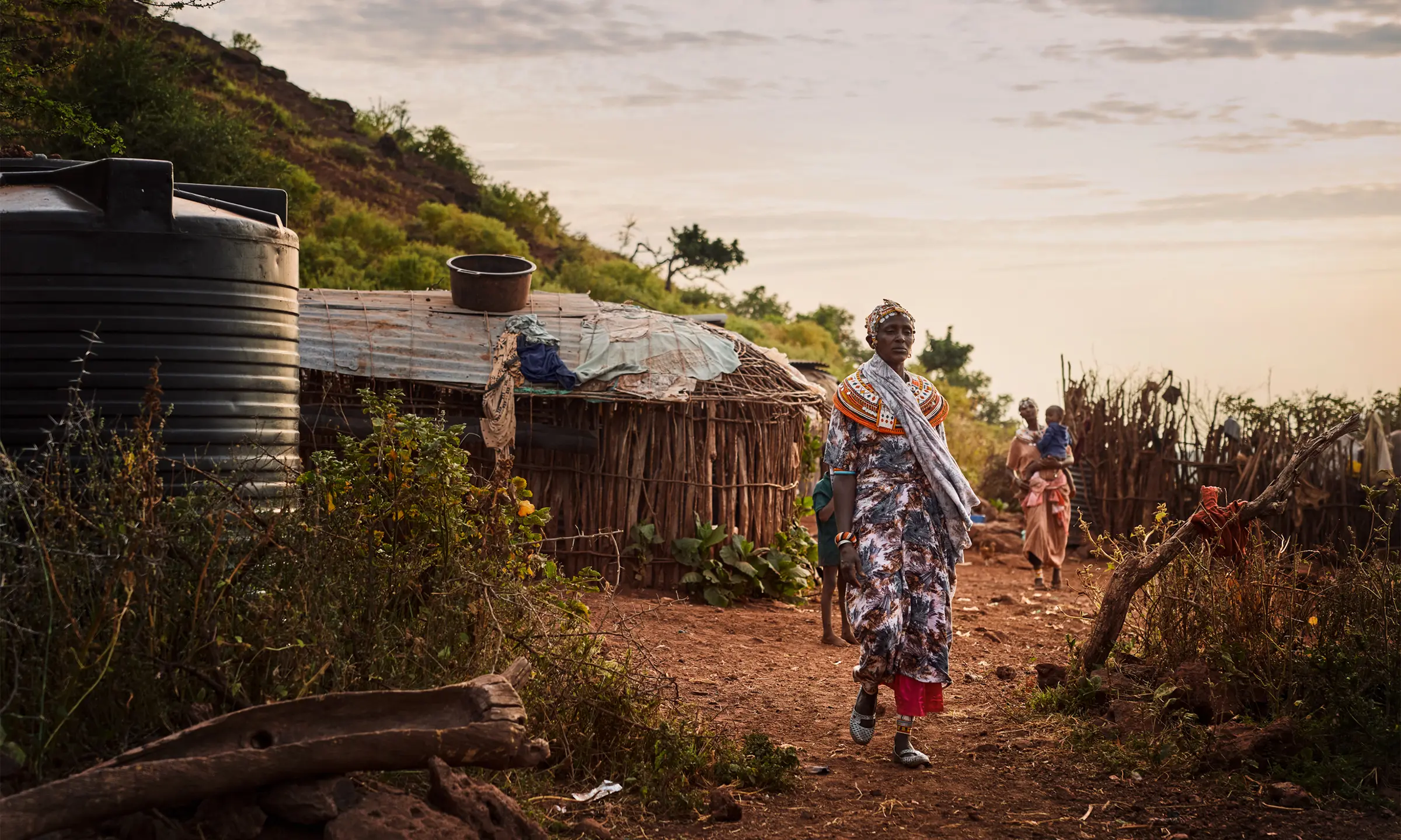 Woman walks through African village