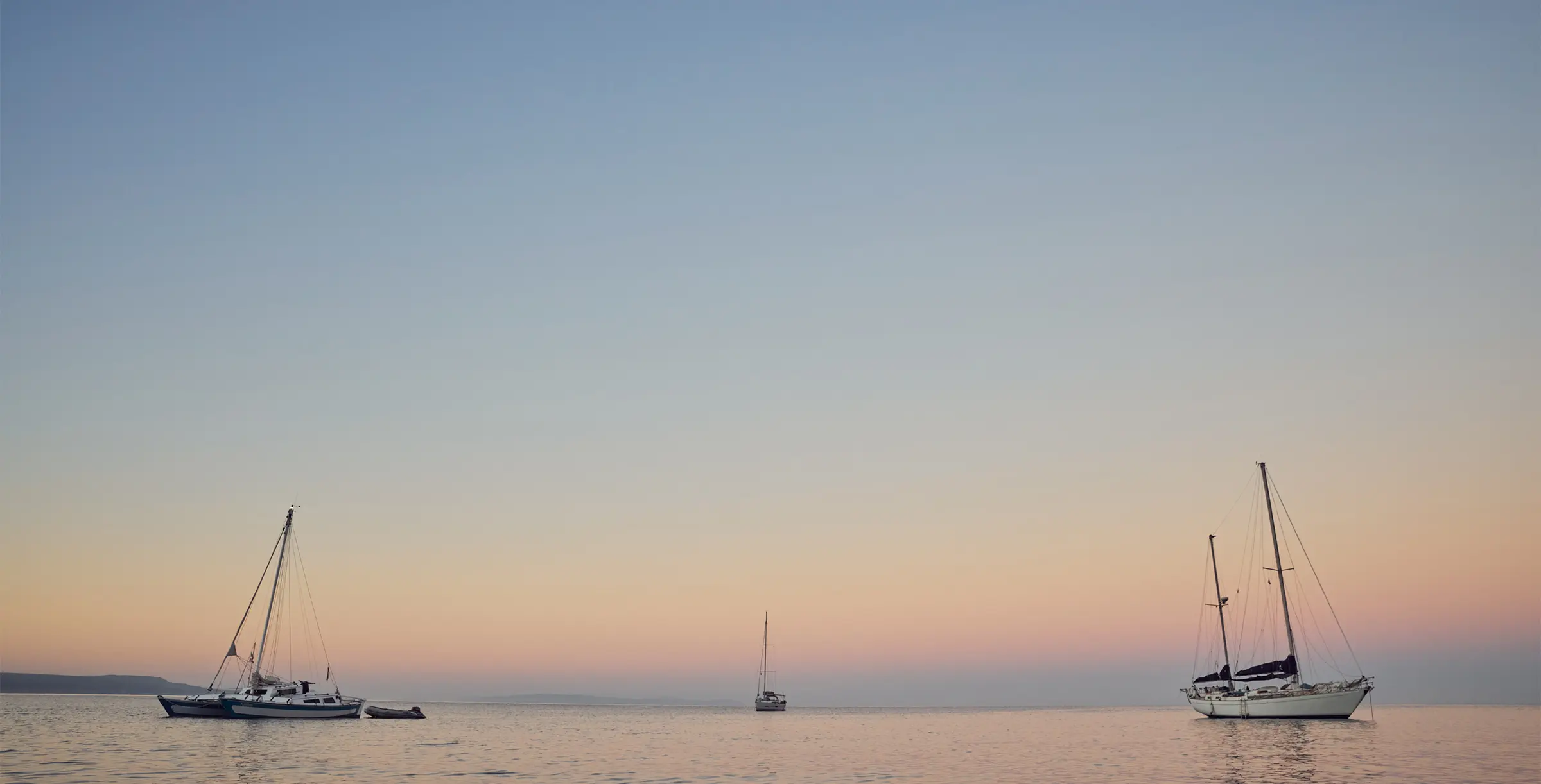 Sailboats lying in the water at dawn