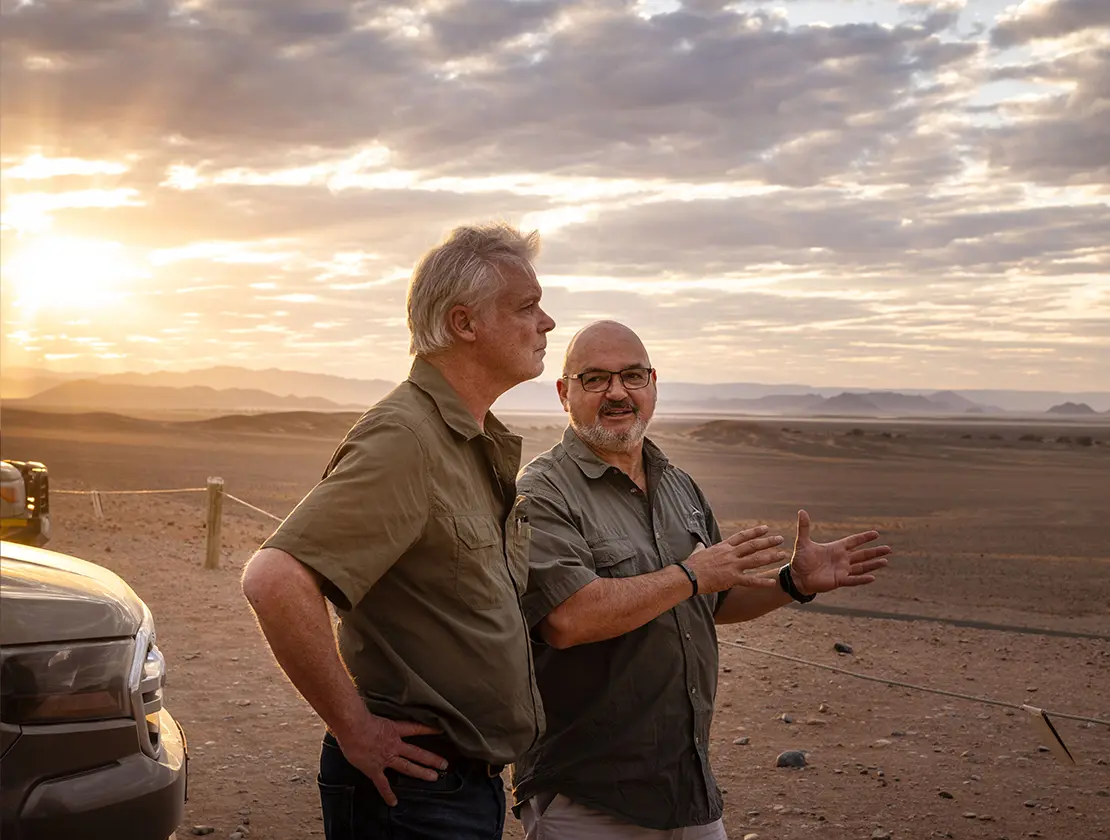 Two men talking in the desert
