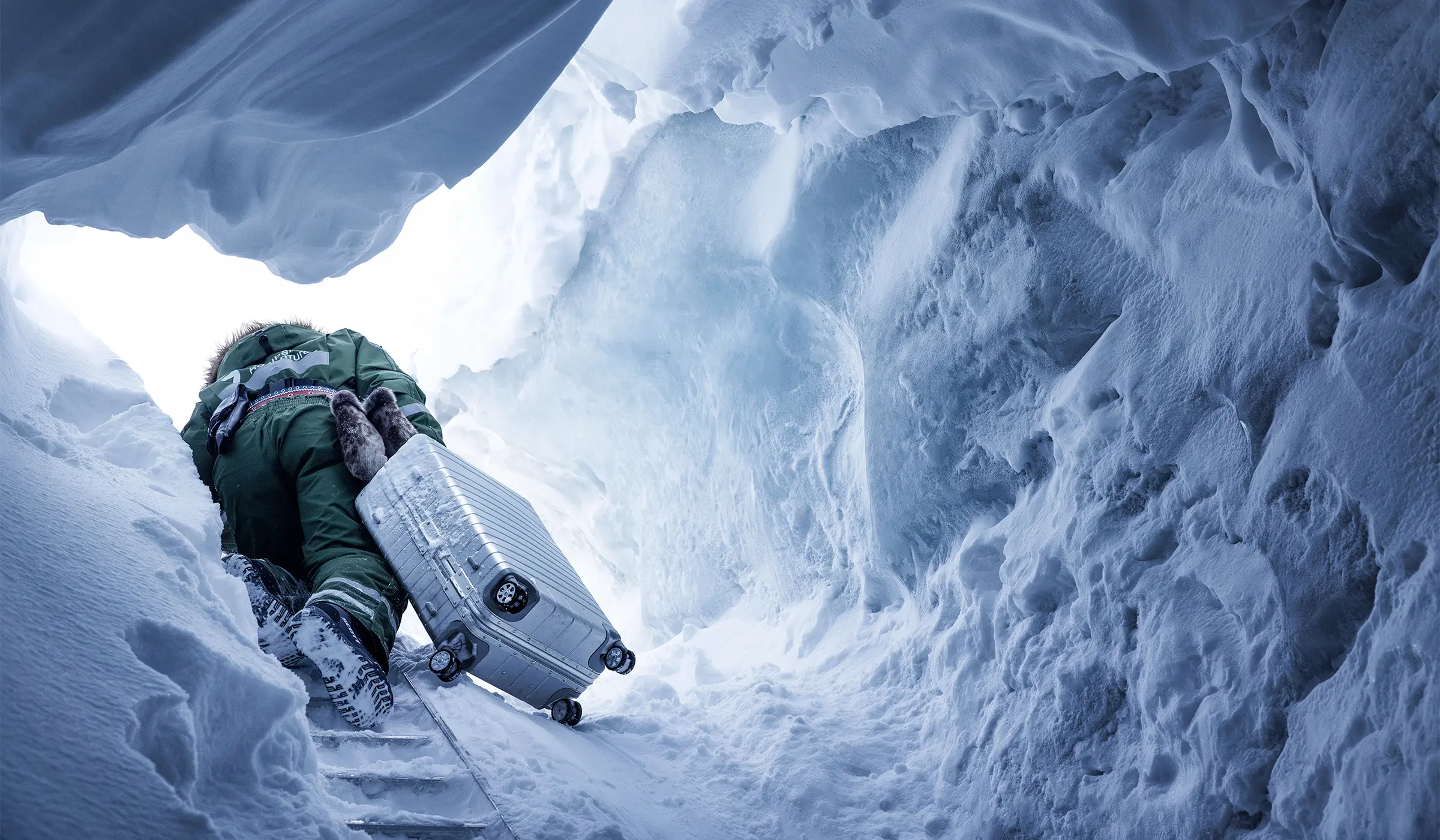 Man with suitcase in ice cave