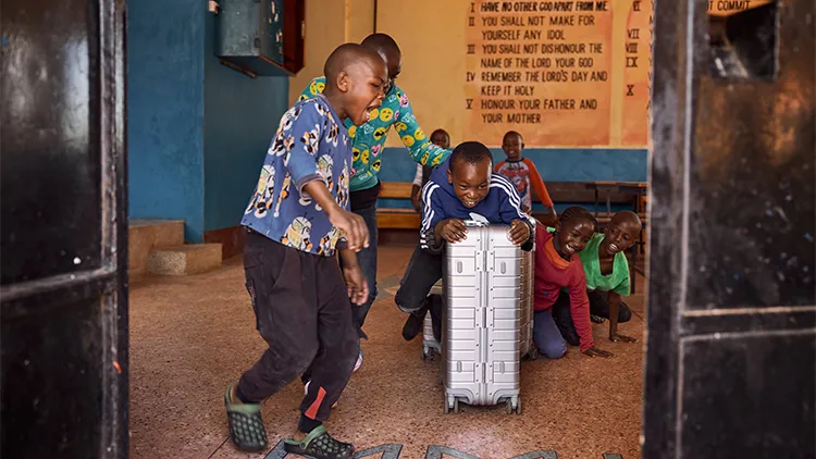 Children playing with a suitcase