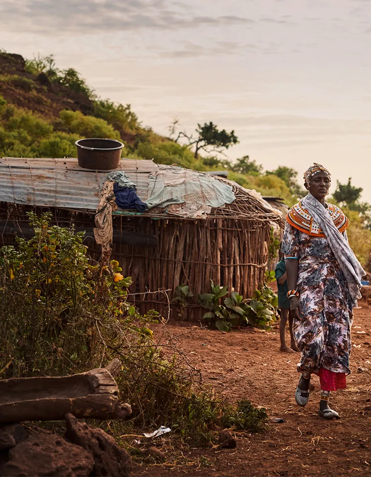 Woman walks through African village