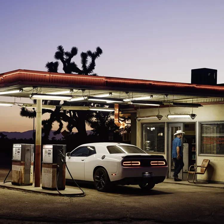 Car at petrol station at dusk